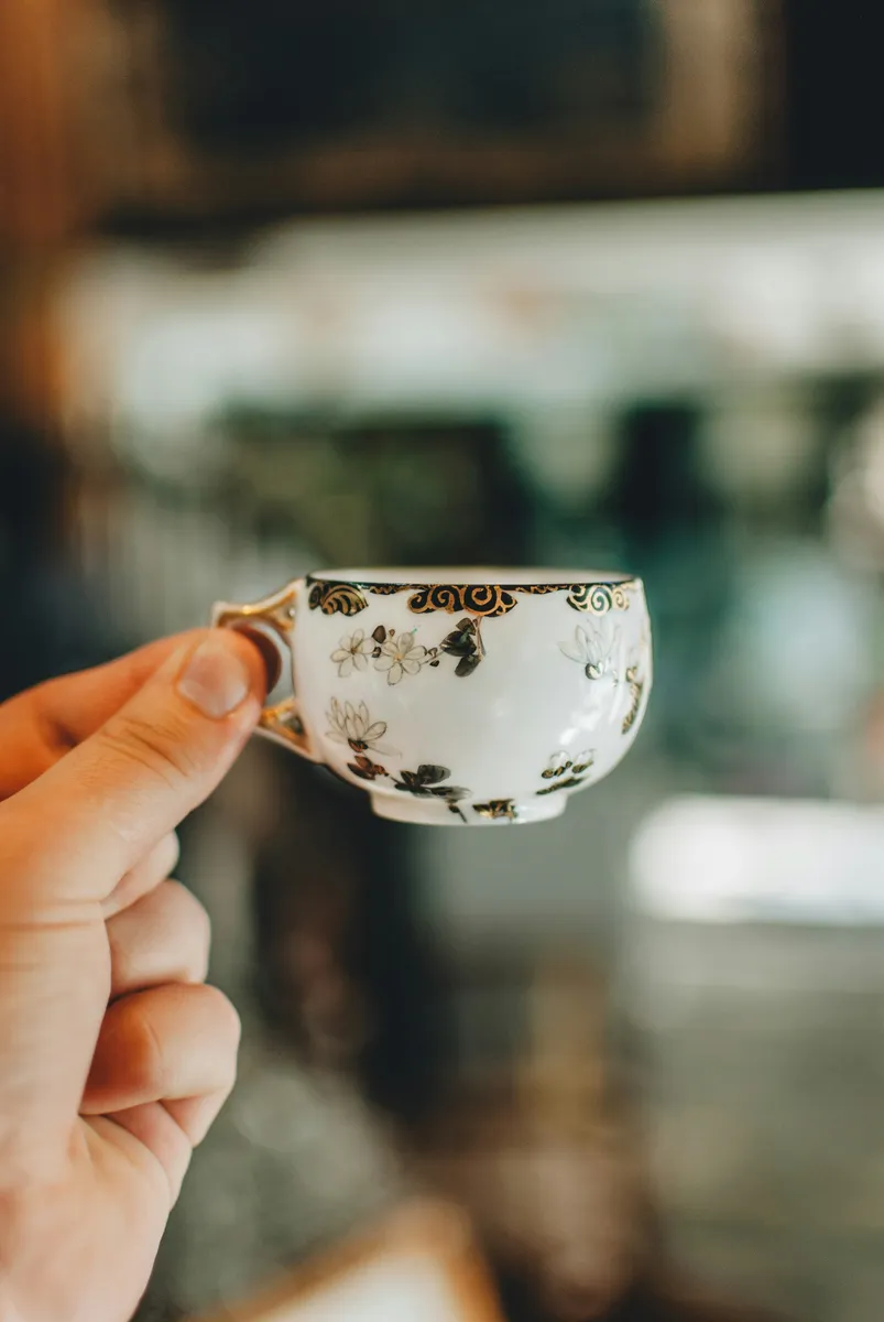 Antique Hand-Painted Porcelain Tea Cup with Floral Motif